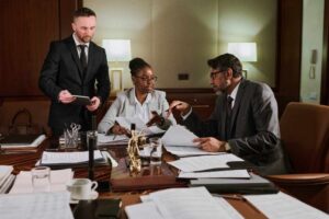 business-professionals-meeting-to-negotiate-debt-and-reduce-debt-payments-in-an-office-setting